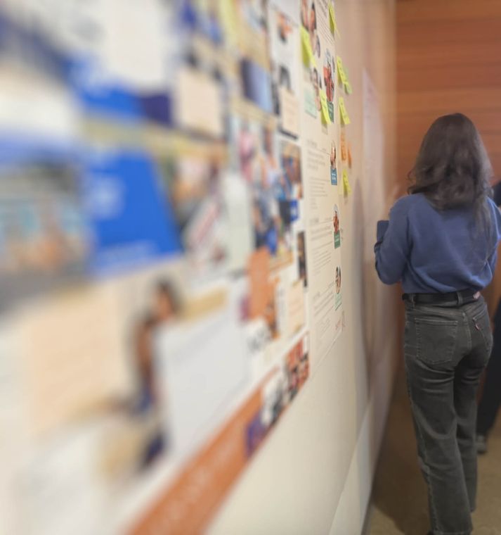 Customer journey mapping workshop Customer journey mapping workshop: participant reviewing a wall-sized journey map of photos and sticky notes