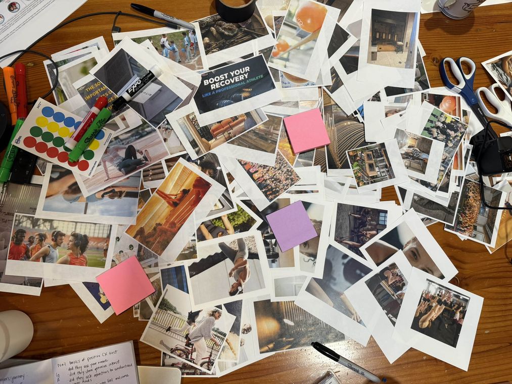 Customer research moodboard exercise Customer research moodboard exercise: printed photographs, sticky notes and markers on a workshop table for brand and customer experience strategy